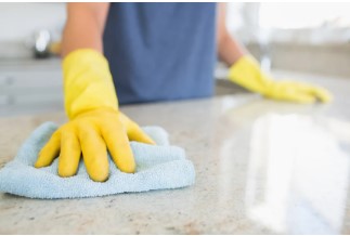 Woman-cleaning-the-counter-in-the-kitchen