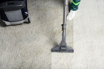 high-angle-view-of-person-cleaning-white-carpet